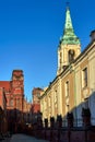 The belfry of a church and facades of historic tenement houses in Torun Royalty Free Stock Photo