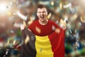 A Belgian fan, a fan of a man holding the national flag of Belgium in his hands. Soccer fan in the stadium. Mixed media Royalty Free Stock Photo