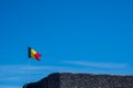 Belgian flag waving on a medieval wall against a blue sky Royalty Free Stock Photo