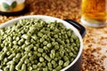 Belgian hops granulated in a clay dish.