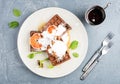 Belgian soft waffles with blood orange, cream, marple syrup and mint on white plates