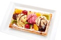 Belgian waffle with fruit, ice cream, chocolate. Royalty Free Stock Photo