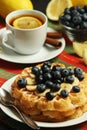 Belgian waffles with blueberry and a cup of tea with lemon Royalty Free Stock Photo