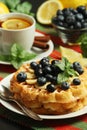 Belgian waffles with blueberry and a cup of tea with lemon Royalty Free Stock Photo