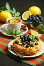 Belgian waffles with blueberry and a cup of tea with lemon Royalty Free Stock Photo