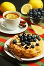 Belgian waffles with blueberry and a cup of tea with lemon Royalty Free Stock Photo