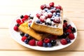 Belgian waffles with blueberry and raspberry powdered by caster Royalty Free Stock Photo