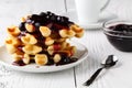 Belgian waffles with creem and berrie jam on white wooden background