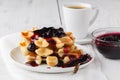 Belgian waffles with creem and berrie jam on white wooden background