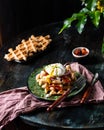 Belgian waffles with egg, arugula, tomatoes and dried meat. Savory waffles. Breakfast concept. poached egg. Sun-dried Royalty Free Stock Photo