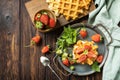 Belgian waffles with fresh berrie strawberries and ricotta cheese for breakfast on a rustic table. View from above. Copy space