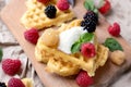 Belgian waffles with fresh raspberries and honey syrup