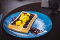 Belgian waffles with fruit. Mango and blueberry