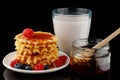 Belgian waffles with honey, yogurt and berries Royalty Free Stock Photo