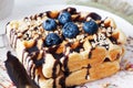 Belgian waffles with peanut chocolate sauce and blueberry, bilberry, whortleberry, huckleberry, hurtleberry, blaeberry Royalty Free Stock Photo