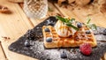 Belgian waffles with a scoop of ice cream, fresh berries raspberries, blackberries, blueberries and mint. Dusted with icing sugar Royalty Free Stock Photo