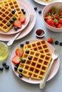 Belgian waffles with strawberries and honey on gray background. Healthy breakfast concept Royalty Free Stock Photo