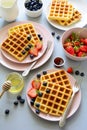 Belgian waffles with strawberries and honey on gray background. Healthy breakfast concept Royalty Free Stock Photo