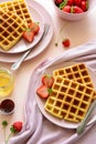 Belgian waffles with strawberries and honey on pink background. Healthy breakfast concept Royalty Free Stock Photo