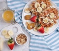 Belgian waffles with syrup, berries and honey, breakfast on a light background, Selective focus