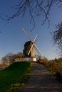 Belgium, Bruges, Bonne Chiere, a close up of a lush green field with path leading to windmill sunset