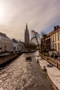 Belgium, Bruges, Brugge, a boat on the canal with church of our lady in the background Royalty Free Stock Photo