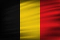 Belgium flag of silk on fabric texture background. Royalty Free Stock Photo