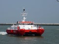 Belgium, Ostende May 3 2013 025 p.m., A red motor catamaran arriving in the harbor, used as a pilot ship, equipped with all