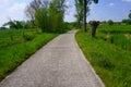 Belgium in spring. Winding Macadam road. Royalty Free Stock Photo