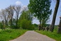 Belgium in spring. Winding Macadam road. Royalty Free Stock Photo