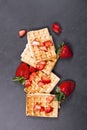 Belgium waffers with strawberries on black board background