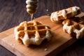 Belgium Waffle with Maple Syrup on wooden surface. Royalty Free Stock Photo