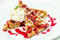 Belgium waffles with fruit sauce, ice cream with nut crumb and m Royalty Free Stock Photo