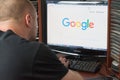 Belgorod, Russia - December 11, 2017: Man uses Google search. A white man sitting at the computer. On the monitor before his eyes