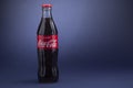 Belgorod , Russia - MAY, 28, 2020: Classic Coca-Cola bottle on Blue Background. Carbonated soft drink produced by Coca-Cola Royalty Free Stock Photo