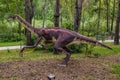 Dinopark of Belgorod city. Statue of Ornithomimus in forest