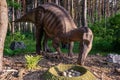 Full-size mayasaur statue in the forest of Belgorod dinopark. Dinosaur-parent with egg laying