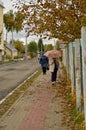 Belgorod, Russia-October 5th, 2019: Rainy, windy and wet autumn weather. People under an umbrella walking down the street among