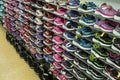 Shopping rows in shoes store. Multi-storey shelve with rows of childrens sneakers