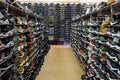 Shopping rows in shoes store. Multi-storey shelves with rows of man sneakers.