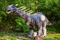 Statue of amargasaurus in the forest. Dinopark of Belgorod city