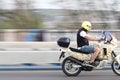 One young man riding fast motorbike over the city street bridge