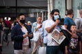 Selective blur on two Young men wearing a respiratory face mask using smartphones in the street of Belgrade, during the covid