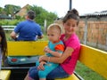 Belgrade, Serbia - August 29, 2019 a teenage girl and a little boy ride in a special passenger trailer from a tractor. They are