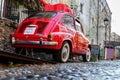 Belgrade, Serbia - December 23, 2022: Oldtimer showcase red car with Christmas presents on the roof in the Skadarlija street