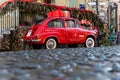 Belgrade, Serbia - December 23, 2022: Oldtimer showcase red car with Christmas presents on the roof in the Skadarlija street