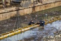 Divers working on concrete revetment and set concrete form work