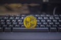 One gold Ripple Coin on keyboard