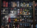 Selective blur on the shelves and racks of a liquor store seen from the window in belgrade stacked with bottles of alcohol