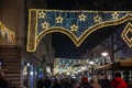 BELGRADE, SERBIA - JANUARY 7, 2023: Selective blur on a Crowd walking at night on Kneza Mihailova street with shops in old town